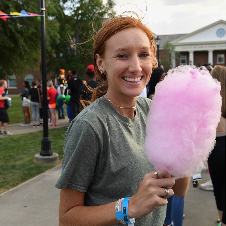A student at CINO Day enjoying cotton candy