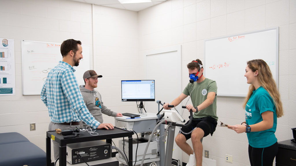 A CCU professor and students performing a sport science lab