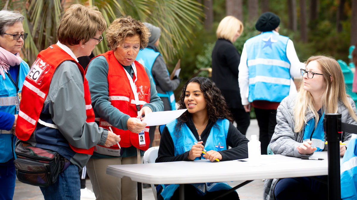 A group of public health volunteers instructing a CCU student