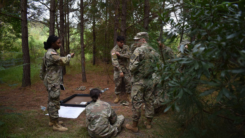 A group of CCU ROTC cadets in a wooded area