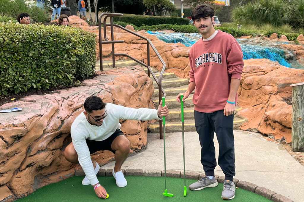 Photo of two CCU students on mini golf course at RSM Mini Golf Tournament