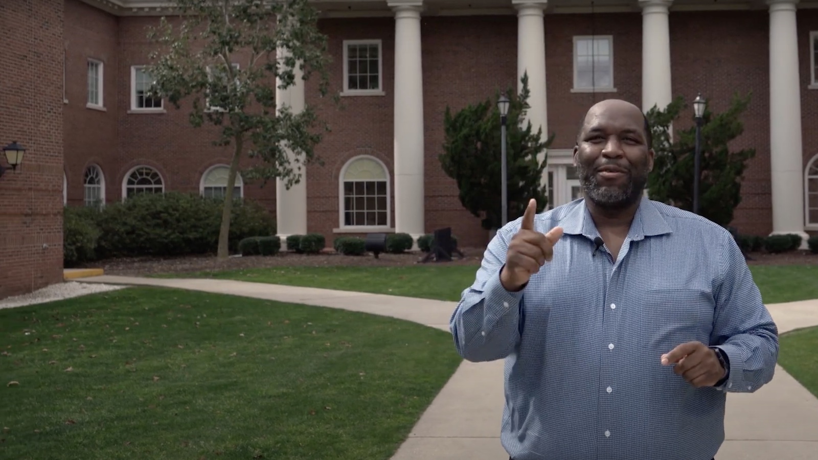 Steven Taylor, Director of Student Success, in front of the Edwards College of Humanities and Fine Arts.