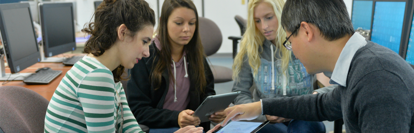 A picture of students looking at a tablet at Coastal Carolina University