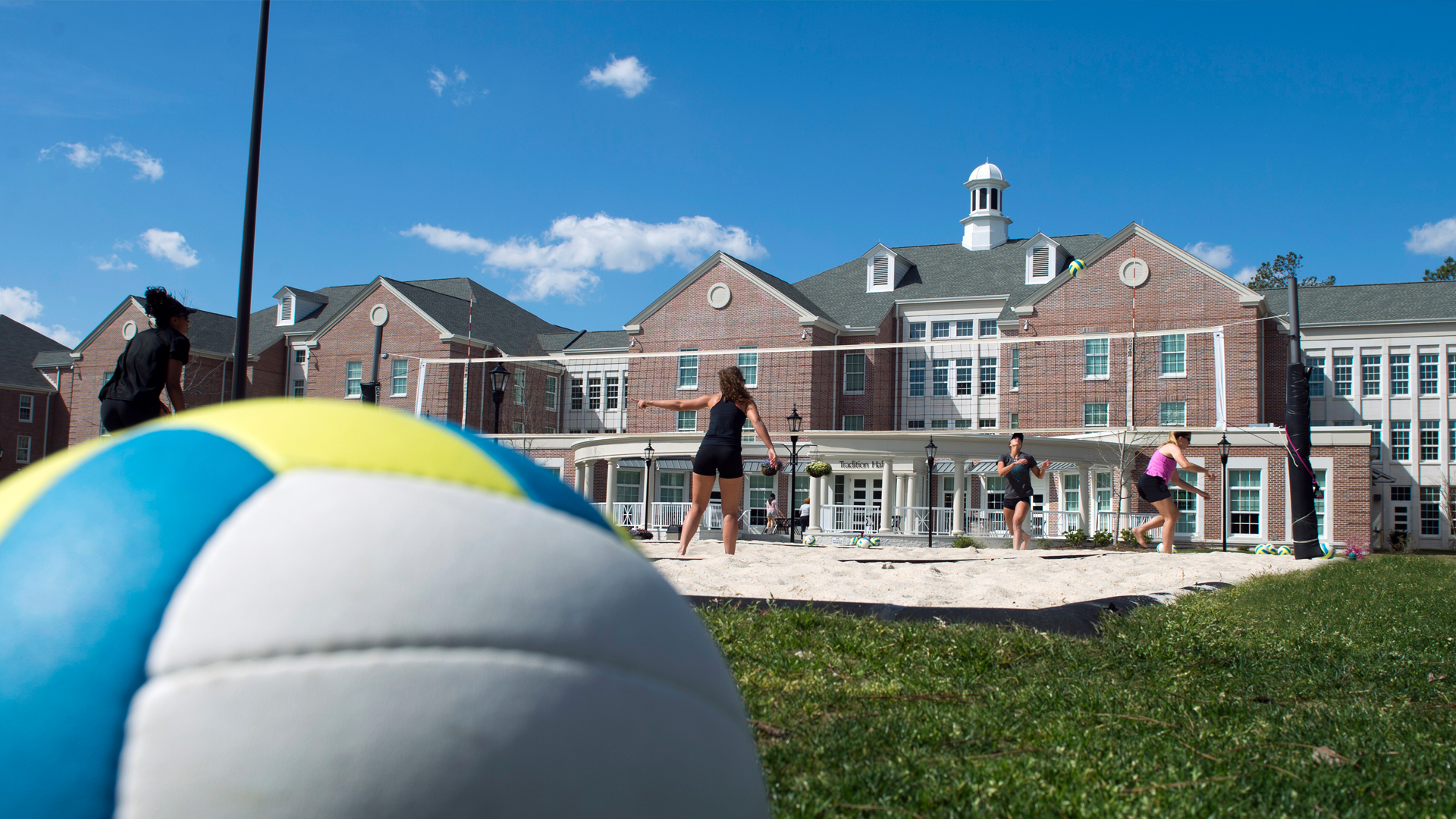 A volleyball match happening in front of the Coastal Carolina University Residence Halls
