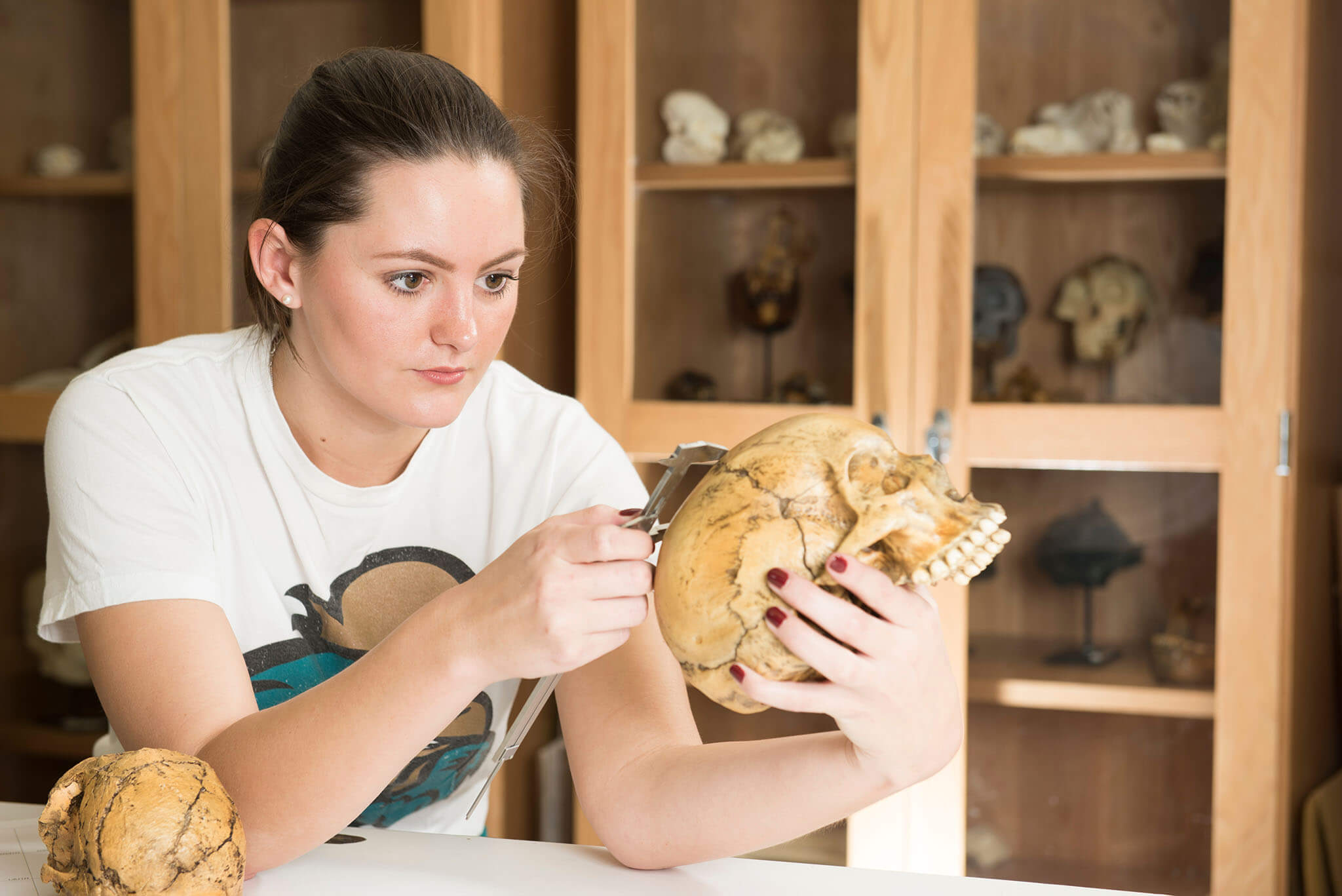 A student holding a human skull